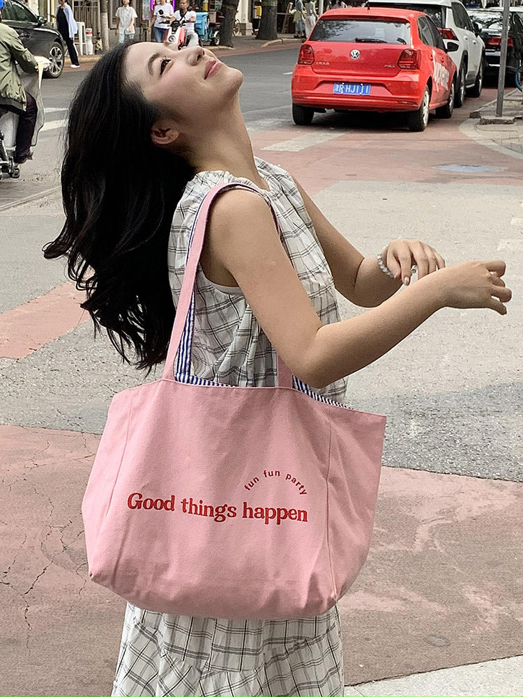 Reversible striped shoulder bag