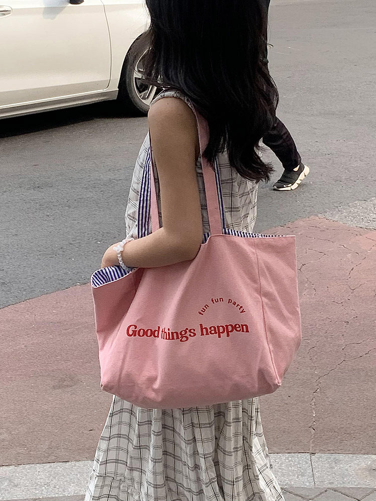 Reversible striped shoulder bag