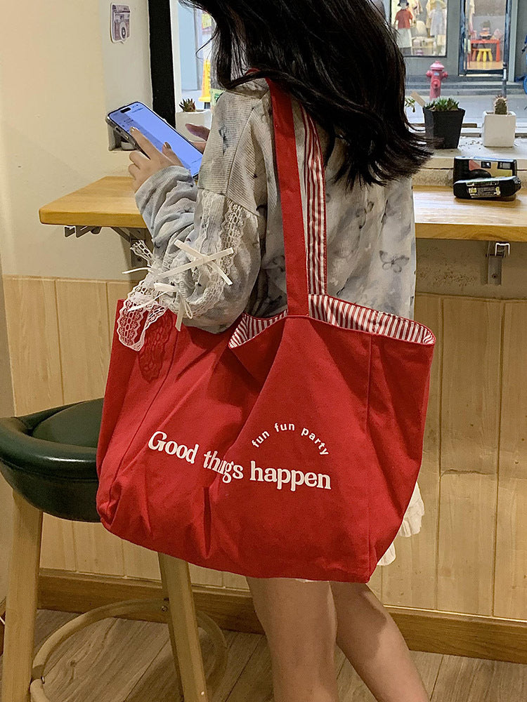 Reversible striped shoulder bag