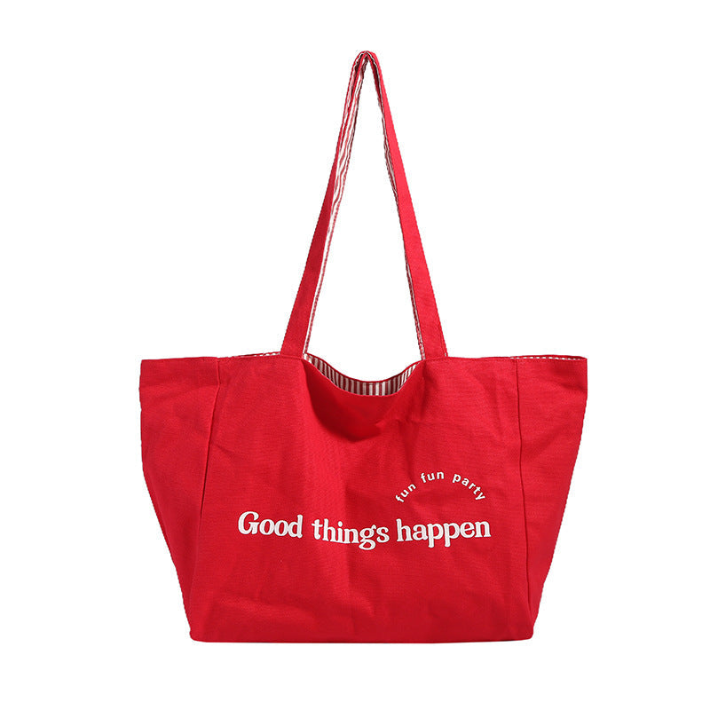 Reversible striped shoulder bag